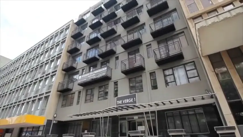 Student res building located at 42 De Korte Street, Braamfontein. Building is light grey in color and is six stories high.