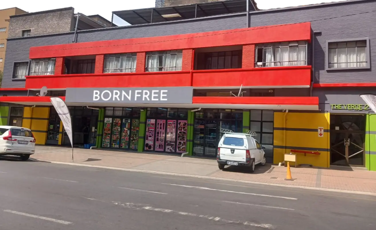 A colourful building in Braamfontein with a red facade featuring the text "BORN FREE STUDENT RES."